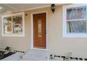 Inviting wood front door with a glass insert at 219 6Th Sw Ave, Largo, FL 33770
