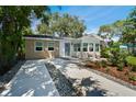 Modern bungalow with two-tone exterior and landscaping at 426 Lexington St, Dunedin, FL 34698