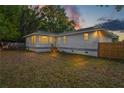 Spacious backyard with wooden fence and large grassy area at 2305 Sugarbush Dr, Holiday, FL 34690