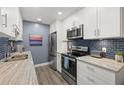 Modern kitchen with stainless steel appliances and granite counters at 8911 Blind Pass Rd # 305, St Pete Beach, FL 33706