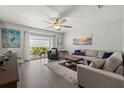 Bright living room with comfortable seating and large window at 8911 Blind Pass Rd # 305, St Pete Beach, FL 33706