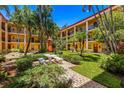 Community courtyard with seating area and BBQ grill at 8911 Blind Pass Rd # 305, St Pete Beach, FL 33706