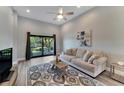 Bright living room with comfy couch and access to a balcony at 7050 Sunset S Dr # 104, South Pasadena, FL 33707