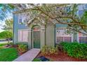 Green townhouse with private entrance and landscaping at 9028 Lake Chase Island Way, Tampa, FL 33626
