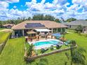 Relaxing pool area with solar panels and patio furniture at 10177 Sunburst Ct, Spring Hill, FL 34608