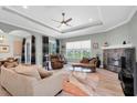Open living area featuring a cozy fireplace and ample seating at 435 Westwinds Drive, Palm Harbor, FL 34683