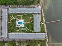 Aerial view of waterfront community with pool and parking at 650 Pinellas Point S Dr # 106, St Petersburg, FL 33705