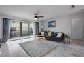 Living room with comfortable seating and large windows at 200 Country Club Dr # 1004, Largo, FL 33771
