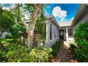 Home's exterior featuring a brick pathway and lush landscaping at 903 San Carlos Ne Ave, St Petersburg, FL 33702