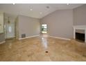 Spacious living room with tile floors, fireplace, and high ceilings at 903 San Carlos Ne Ave, St Petersburg, FL 33702