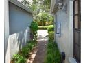 Brick pathway between buildings, showcasing landscaping and fountain at 903 San Carlos Ne Ave, St Petersburg, FL 33702