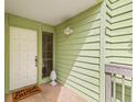 Front entrance with white door and tiled flooring at 320 Windrush Blvd # 4, Indian Rocks Beach, FL 33785