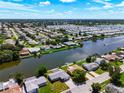 Aerial view showcasing a waterfront community with numerous homes and canals at 2248 Society Dr, Holiday, FL 34691