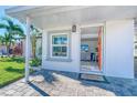 House exterior with an orange door and paved walkway at 142 Beach Ave, Redington Shores, FL 33708