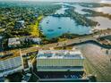 Overhead view showcasing the building's location on the water, surrounded by lush greenery and other waterfront properties at 100 Bluff View Dr # 405C, Belleair Bluffs, FL 33770