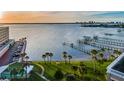 Picturesque water view featuring a well-maintained lawn with palm trees and waterfront with private boat docks at 100 Bluff View Dr # 405C, Belleair Bluffs, FL 33770