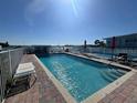 Community pool with lounge chairs and patio area at 1840 Shore S Dr # 5, South Pasadena, FL 33707