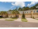 Exterior view of townhouses with garages and landscaping at 17860 Althea Blue Pl, Lutz, FL 33558