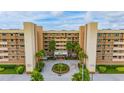 Oceanfront building with lush landscaping and parking at 14900 Gulf Blvd # 212, Madeira Beach, FL 33708