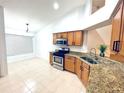 Bright kitchen featuring stainless steel appliances and granite countertops at 31207 Chatterly Dr, Wesley Chapel, FL 33543