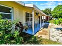 Inviting covered porch with seating, perfect for enjoying the outdoors and beautiful landscaping at 6220 5Th S Ave, St Petersburg, FL 33707