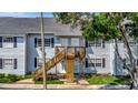 Two-story building exterior with stairs and landscaping at 5695 67Th N Ave # 122, Pinellas Park, FL 33781