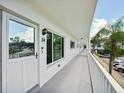 Clean condo hallway with white walls and railing at 2430 Brazilia Dr # 24, Clearwater, FL 33763