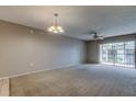 Spacious living room with carpet, ceiling fan, and sliding glass doors to balcony at 106 Pine Ct # 106, Oldsmar, FL 34677