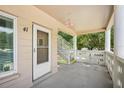 Front door entrance to an apartment unit with a private balcony at 2435 Sumatran Way # 41, Clearwater, FL 33763