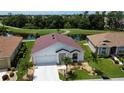 Single-story home with red tile roof, overlooking a golf course at 24327 Buckingham Way, Punta Gorda, FL 33980