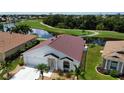 Single-story house with red tile roof, situated near a lake at 24327 Buckingham Way, Punta Gorda, FL 33980