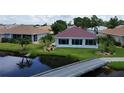 Back of house with pool and view of canal at 24327 Buckingham Way, Punta Gorda, FL 33980
