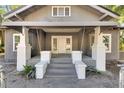Quaint front porch with white columns and wooden flooring at 907 E North Bay St, Tampa, FL 33603