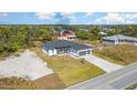 Birds-eye view of attractive modern home with manicured lawn near community, showcasing neighborhood at 14346 San Domingo Blvd, Port Charlotte, FL 33981