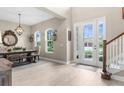Open-concept room featuring a formal dining area with luxury wood-like tile at 32924 Estate Garden Dr, Wesley Chapel, FL 33545