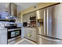 Updated kitchen featuring stainless steel appliances, stylish cabinetry, granite countertops, and backsplash at 5820 43Rd N Ter # 1406, St Petersburg, FL 33709