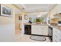 Practical kitchen area with ample counter space and appliances, open to living areas at 12200 Vonn Rd # 1209, Largo, FL 33774