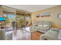 Cozy living room with wood floors, comfortable seating, and sliding doors to the outside at 12200 Vonn Rd # 1209, Largo, FL 33774