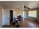 Bedroom with hardwood floors, ceiling fan, and natural light from a large window at 6312 Fairway Blvd, Apollo Beach, FL 33572