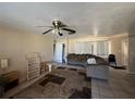 Bright living room with tiled floors, a ceiling fan, and ample natural light at 6312 Fairway Blvd, Apollo Beach, FL 33572