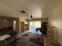 Spacious living room featuring tiled floors and sliding glass doors to the backyard at 6312 Fairway Blvd, Apollo Beach, FL 33572