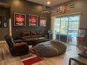 Inviting living room with wood-look tile, and access to the outdoor space at 4749 Stoneview Cir, Oldsmar, FL 34677