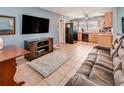 Open-concept living room seamlessly transitions into the kitchen, featuring tile floors and modern appliances at 7226 13Th N St, St Petersburg, FL 33702