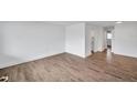 An empty living room features wood-look flooring and pristine white walls, offering a blank canvas at 2353 Shelley St # 21, Clearwater, FL 33765
