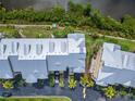 Aerial view of condos with lush landscaping, parking, and close proximity to tranquil river at 603 Bahia Beach Blvd, Ruskin, FL 33570