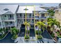 Inviting multi-level condo with palm trees and a metal roof, nestled in a well-maintained community at 603 Bahia Beach Blvd, Ruskin, FL 33570