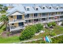 Beautiful condo featuring multiple balconies with outdoor seating and lush green space at 603 Bahia Beach Blvd, Ruskin, FL 33570