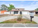 Charming two-story home showcasing a red tiled roof, stucco walls, and a well-manicured front yard at 9100 Suffolk Ln, Port Richey, FL 34668