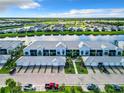 A scenic aerial view showcases the building's design near a serene lake at 14204 Heritage Landing Blvd # 714, Punta Gorda, FL 33955
