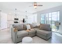 Open-concept living area flowing into a kitchen, featuring sleek design, comfortable sofa, and abundant natural light at 14204 Heritage Landing Blvd # 714, Punta Gorda, FL 33955